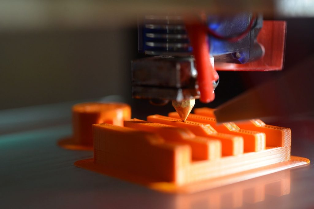 A 3D printer in operation, creating a three-dimensional object layer by layer.