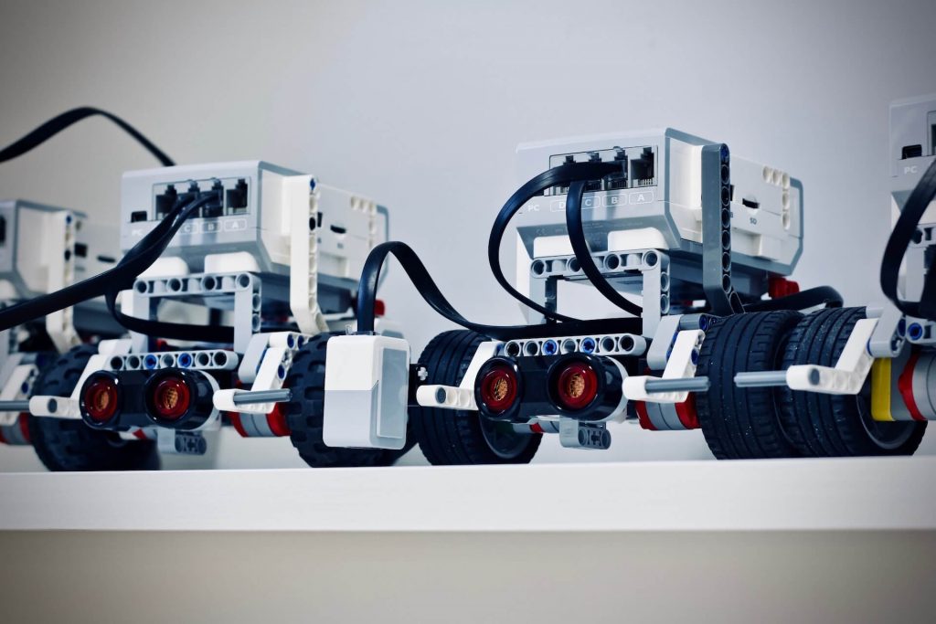 A group of wheeled robots, each equipped with sensors and mechanical components, ready to perform various tasks and navigate their surroundings.